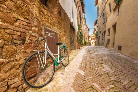 Beautiful and colorful streets of the small and historic Tuscan village Pienza, Italyの写真素材