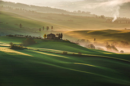 Beautiful Tuscan landscape with long shadows and mistsの写真素材