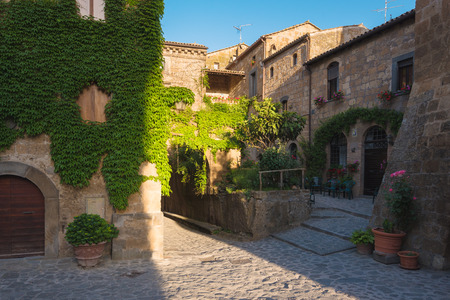 Long shadows of the old walls in the village Civita di Bagnoregio, Italyの写真素材