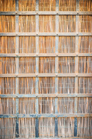 Window with a straw mat and metal barsの写真素材