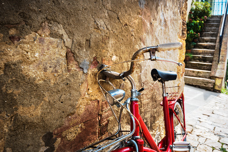 Abandoned bike on the Italian street in the old Tuscanyの写真素材