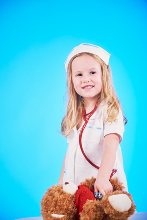 Beautiful nurse examiner little sick brown teddy bear.の写真素材