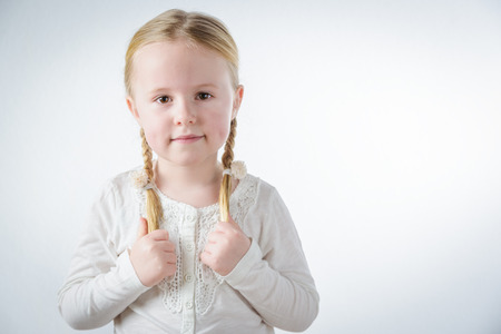 Smiling little blond girl with pigtailsの写真素材
