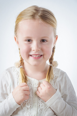 Smiling little blond girl with pigtailsの写真素材