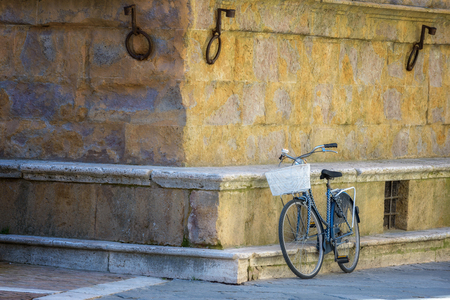 Old vintage bicycle against a wall in Italy.の写真素材