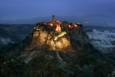 Evening panoramic view of the gorge of the small medieval town in the middle, Civita di Bagnoregio, Italy.の写真素材