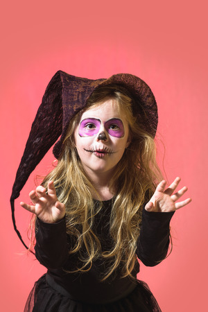 Terribly serious and dangerous witch, a girl dressed  for halloween holiday and the pumpkins.の写真素材