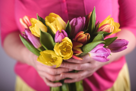 Woman with tulips in spring dayの写真素材