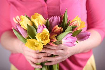 Woman with tulips in spring dayの写真素材