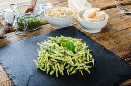 Trofie pasta with vegetarian sauce, pesto with pine nuts and basyli.の写真素材