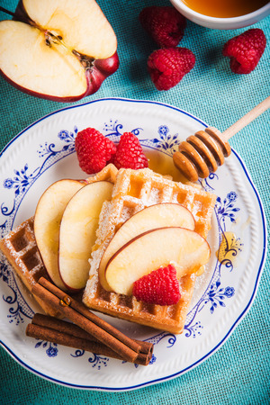 Fresh waffles with fruit and honey.の写真素材