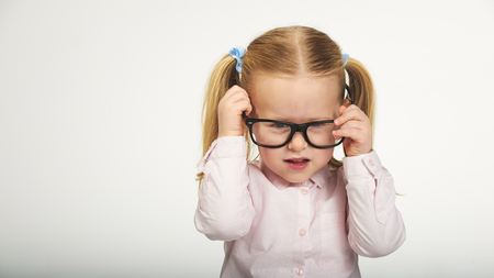 Cute little girl with glasses on a white backgroundの写真素材