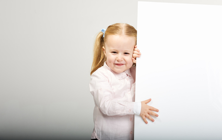 Beautiful little girl with white copy space on a white backgroundの写真素材