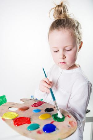 Color images painted by a beautiful blond girl on a white background.の写真素材