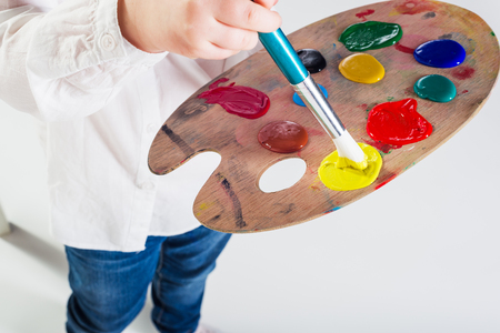 Color images painted by a beautiful blond girl on a white background.の写真素材