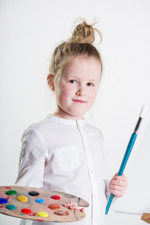 Color images painted by a beautiful blond girl on a white background.の写真素材