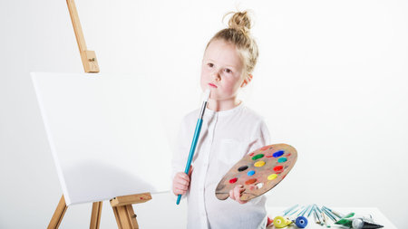 Color images painted by a beautiful blond girl on a white background.の写真素材