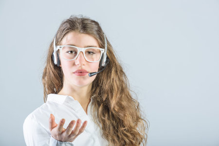 Hard working in corporate telephone service, but smiling beautiful girl.
