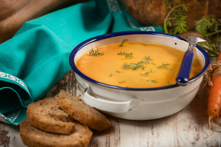 Pumpkin soup with bread crouton on white wood tableの写真素材