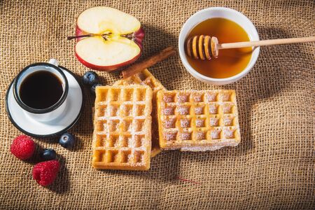 Waffles with fruit, honey and fresh coffee.の写真素材