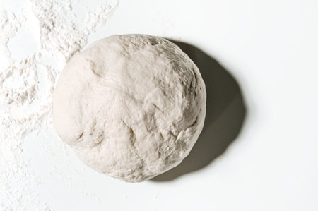 Crushed and prepared pizza dough, cake, bread on the table