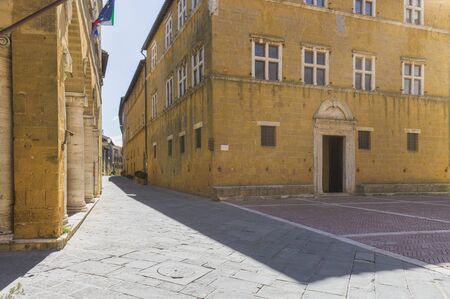 Sunny streets with colorful flowers with contrasting shades. Walk the Tuscan townの写真素材