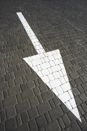 Big white arrow on the roadの写真素材