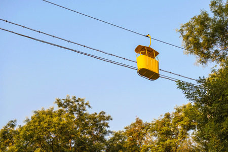 Low angle view of retro yellow cable way empty cabin, early morningの写真素材