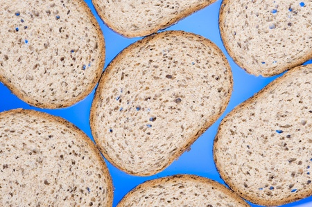 Brown bread slices on blue background
の写真素材