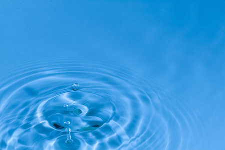 Falling drops of water. Splashing blue water