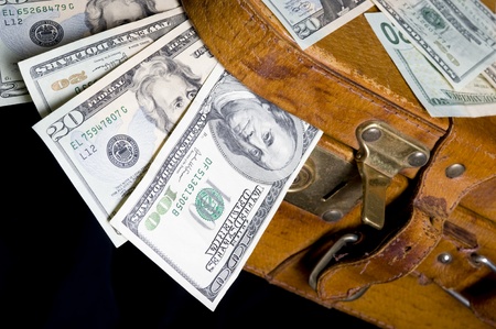 Cash ,dollar sticking out of overfilled caseの写真素材