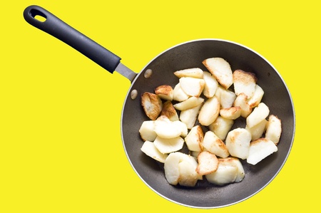 Fried potatoes in frying-pan isolated on blue
の写真素材