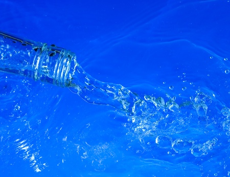 Bottle with splashing blue water
の写真素材