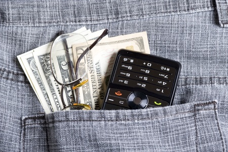 Cell phone in jeans pocket  and dollar
の写真素材