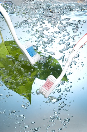Toothbrush on creative background with blue water bubbles
の写真素材