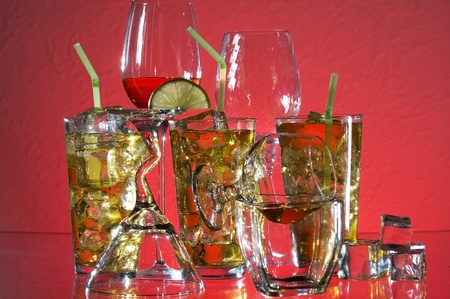 Glass with alcohol and ice on red background
の写真素材