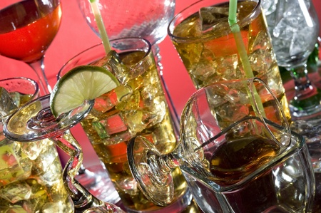 Glass with alcohol and ice on red background
の写真素材
