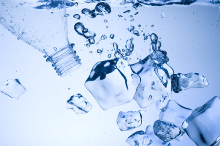 Mineral water with ice. Creative splashing blue water