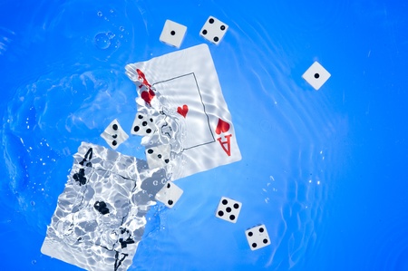 Several dice combination and playing cards on waterの写真素材