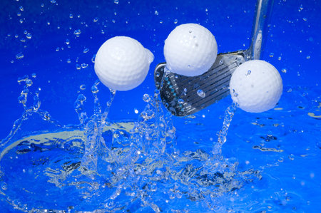 Golf club in blue water. Club with ball の写真素材