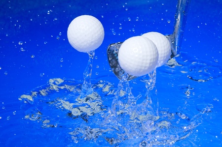 Golf club in blue water. Club with ball の写真素材