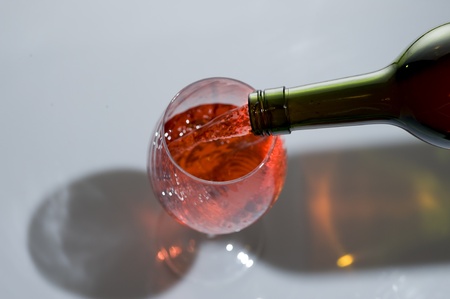 Red wine and bottle isolated on whiteの写真素材