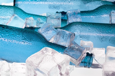 Blue creative bottles and clear ice .Cocktail with iceの写真素材