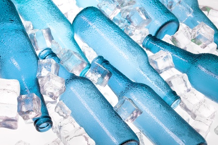 Blue creative bottles and clear ice .Cocktail with iceの写真素材