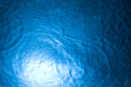 Dark water surface with bubbles