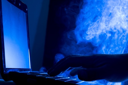 Laptop and human hand on blue background
の写真素材