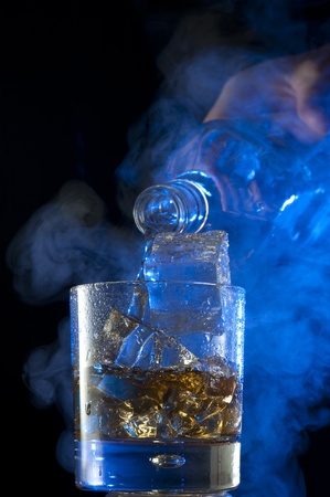 Pouring Whisky . Brandy with iceの写真素材