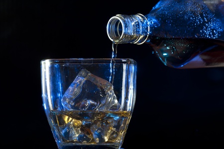 Pouring Whisky . Brandy with iceの写真素材