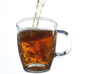 Fresh tea pouring on the glass , white backgroundの写真素材