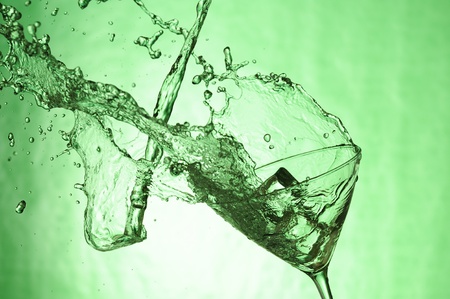 Martiniglass with stream fresh drink. Splashing cocktailの写真素材